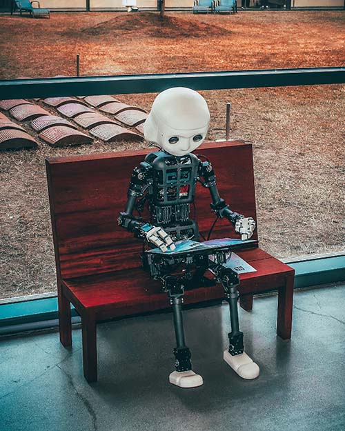 AI Robot Kid at a Park with a Laptop